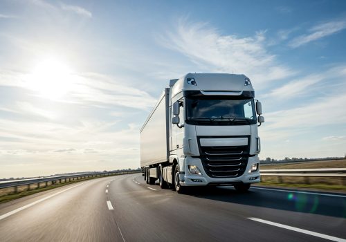 semi-truck-driving-sunny-highway